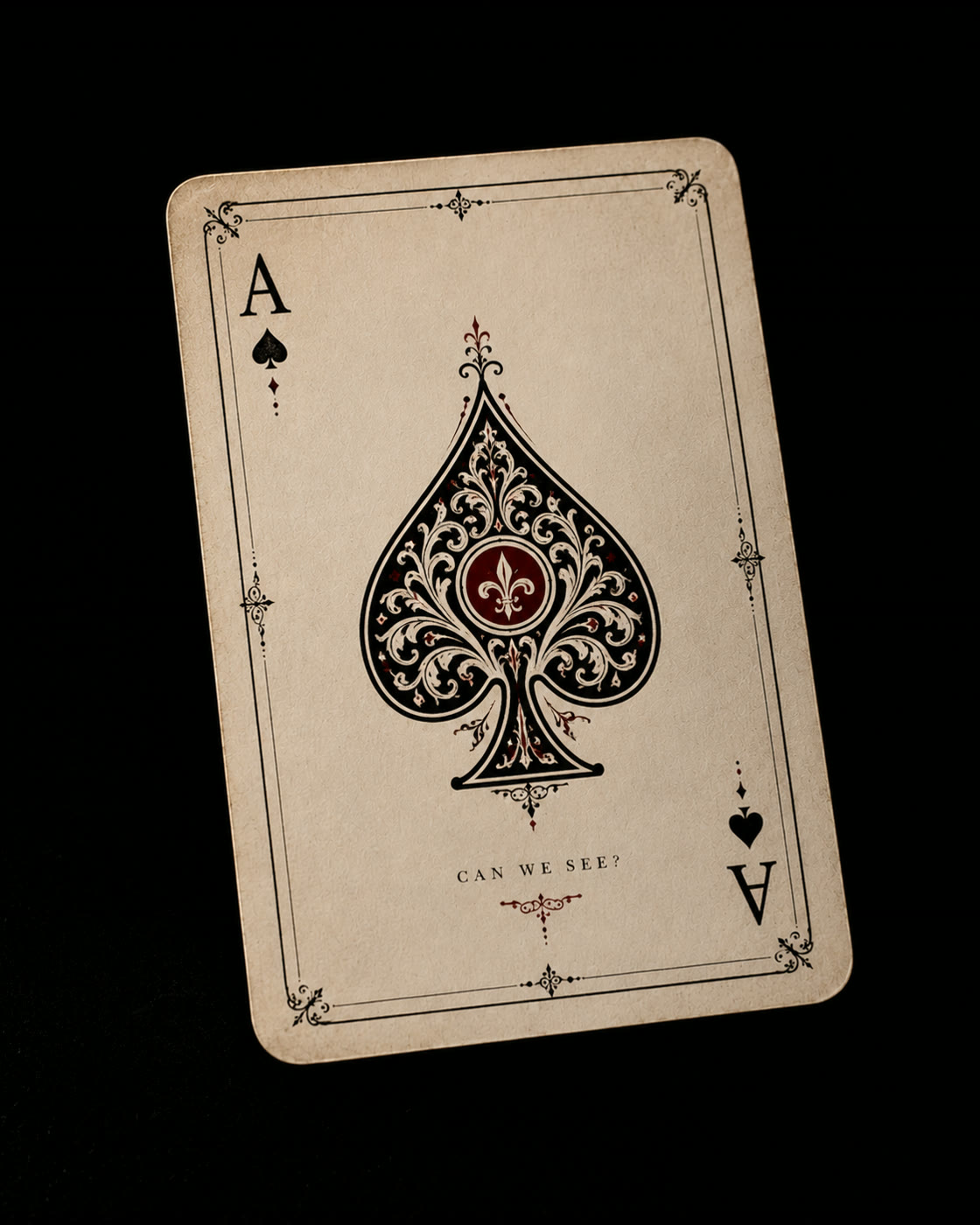An aged ace of spades card with a red flourish